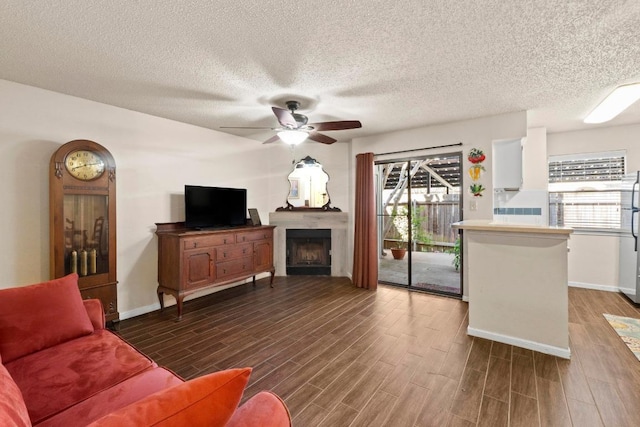 9226 Jollyville Rd Unit 170, Austin, TX 78759 - living room with a ceiling fan, wood finished floors, plenty of natural light, and a textured ceiling