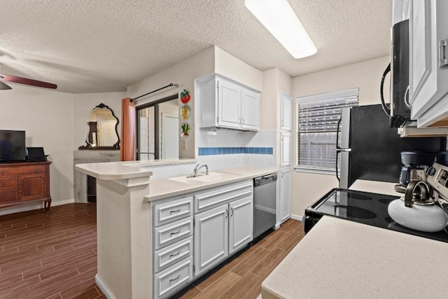 9226 Jollyville Rd Unit 170, Austin, TX 78759 - kitchen with stainless steel appliances, a peninsula, wood tiled floors, a ceiling fan, and a textured ceiling