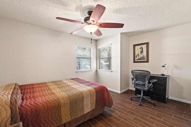 9226 Jollyville Rd Unit 170, Austin, TX 78759 - bedroom with baseboards, a textured ceiling, dark wood-type flooring, and a ceiling fan