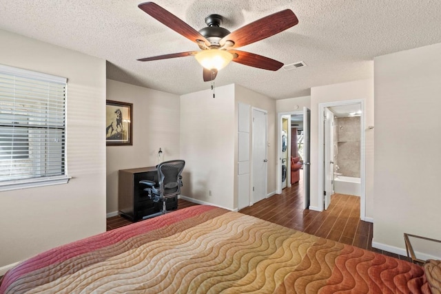 9226 Jollyville Rd Unit 170, Austin, TX 78759 - bedroom with wood finished floors, a textured ceiling, baseboards, and ceiling fan
