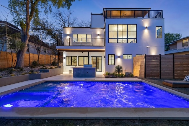 2209 Bowman Ave, Austin, TX 78703 - back of house with a balcony, a fenced backyard, stucco siding, and a patio area