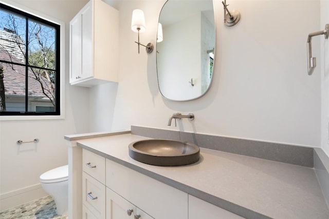 2209 Bowman Ave, Austin, TX 78703 - bathroom with vanity, toilet, baseboards, and tile patterned floors
