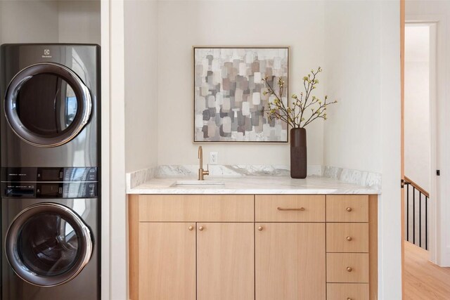 2209 Bowman Ave, Austin, TX 78703 - laundry area featuring stacked washer and clothes dryer, wood finished floors, and wet bar