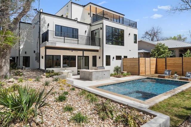 2209 Bowman Ave, Austin, TX 78703 - rear view of house with a balcony, stucco siding, and a patio area