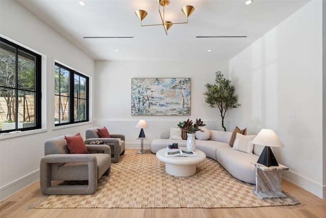 2209 Bowman Ave, Austin, TX 78703 - living room with wood finished floors, a chandelier, recessed lighting, and baseboards