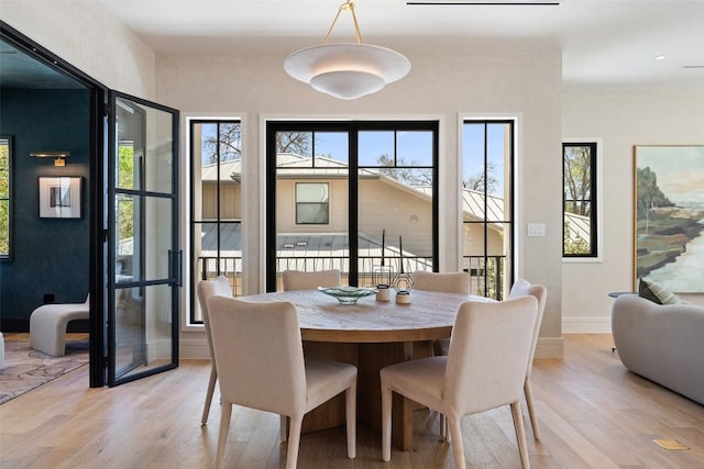 2209 Bowman Ave, Austin, TX 78703 - dining area featuring light wood-style floors, plenty of natural light, and baseboards