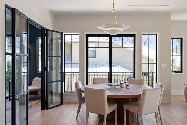 2209 Bowman Ave, Austin, TX 78703 - dining space with light wood-style floors and baseboards
