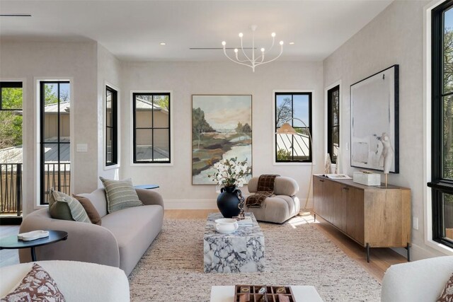 2209 Bowman Ave, Austin, TX 78703 - living area featuring light wood-type flooring, a chandelier, baseboards, and recessed lighting