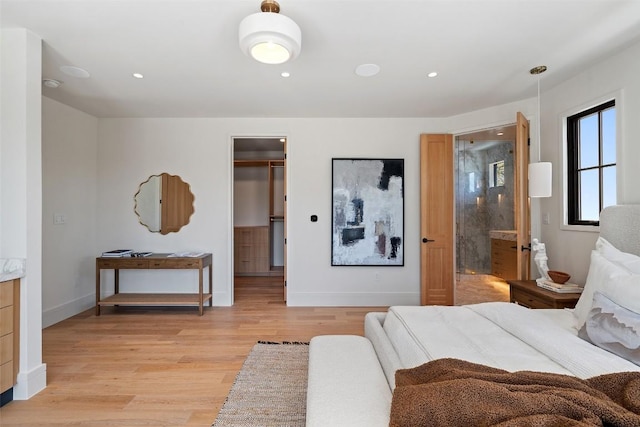 2209 Bowman Ave, Austin, TX 78703 - bedroom with light wood-type flooring, baseboards, a walk in closet, recessed lighting, and ensuite bathroom