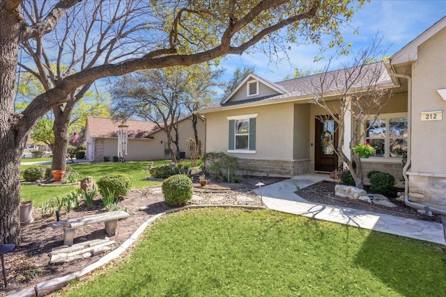 view of front of home featuring a front yard, stucco siding, and stone siding