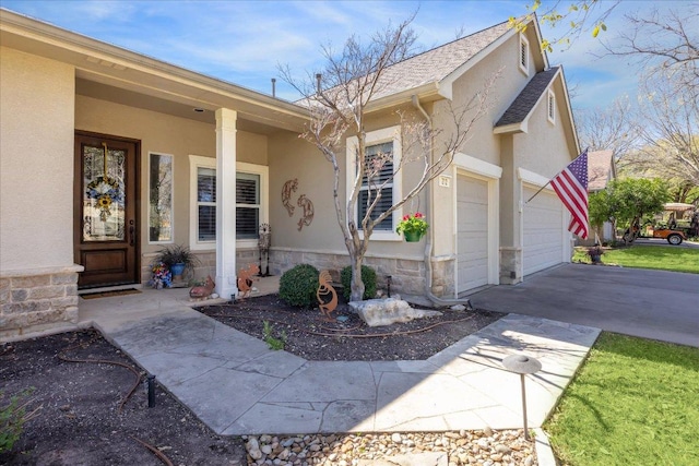 property entrance featuring stone siding, driveway, and stucco siding