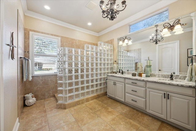 bathroom with a chandelier, a walk in shower, a sink, and ornamental molding