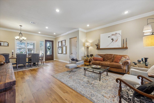 living area featuring a chandelier, visible vents, and recessed lighting