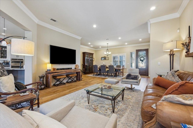 living room with visible vents, light wood-style flooring, recessed lighting, and an inviting chandelier