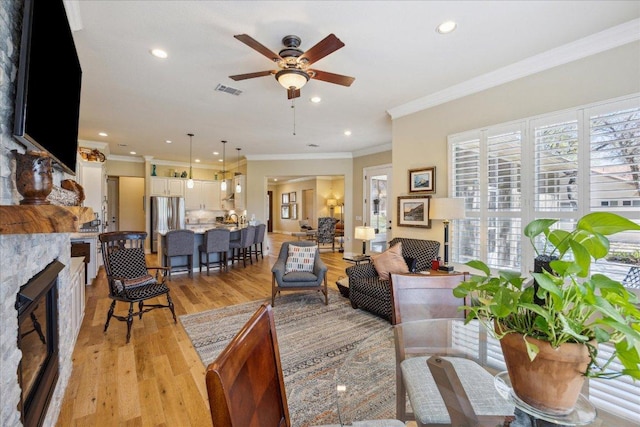 living area with a wealth of natural light, recessed lighting, light wood-style flooring, and ceiling fan