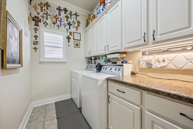 clothes washing area with baseboards, ornamental molding, tile patterned floors, cabinet space, and washing machine and clothes dryer