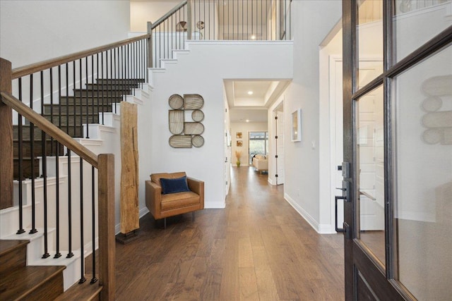 19302 Summit Glory Trl Unit 68, Spicewood, TX 78669 - entrance foyer featuring wood finished floors, stairs, baseboards, and a towering ceiling