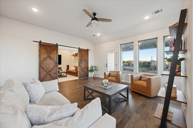 19302 Summit Glory Trl Unit 68, Spicewood, TX 78669 - living room with a barn door, dark wood-type flooring, ceiling fan, recessed lighting, and baseboards