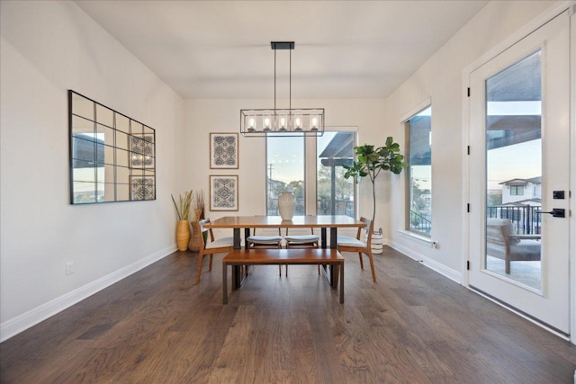 19302 Summit Glory Trl Unit 68, Spicewood, TX 78669 - dining space featuring dark wood finished floors, a chandelier, and baseboards