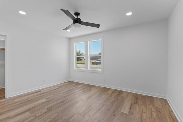 spare room featuring recessed lighting, baseboards, light wood-type flooring, and ceiling fan
