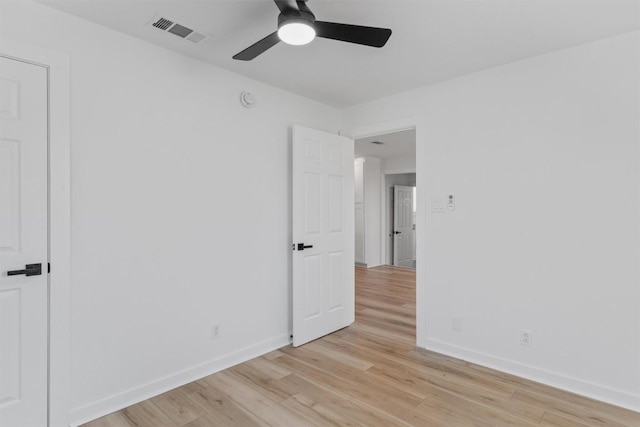 unfurnished room with light wood-type flooring, visible vents, baseboards, and a ceiling fan