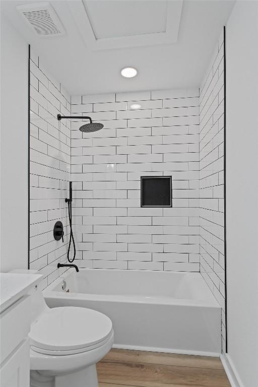 full bathroom with wood finished floors, toilet, tub / shower combination, and visible vents