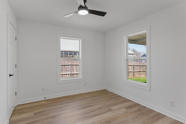 unfurnished room featuring light wood-style flooring, a ceiling fan, and baseboards
