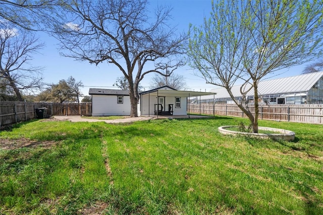 view of yard featuring an outbuilding and a fenced backyard