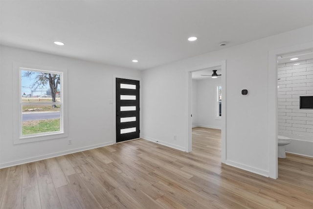 foyer with recessed lighting, light wood-style floors, and baseboards