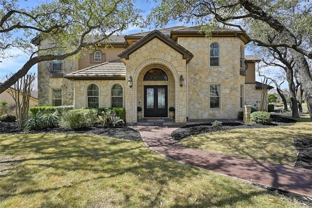 2624 University Club Dr, Austin, TX 78732 - mediterranean / spanish-style house with stone siding, stucco siding, french doors, and a front yard