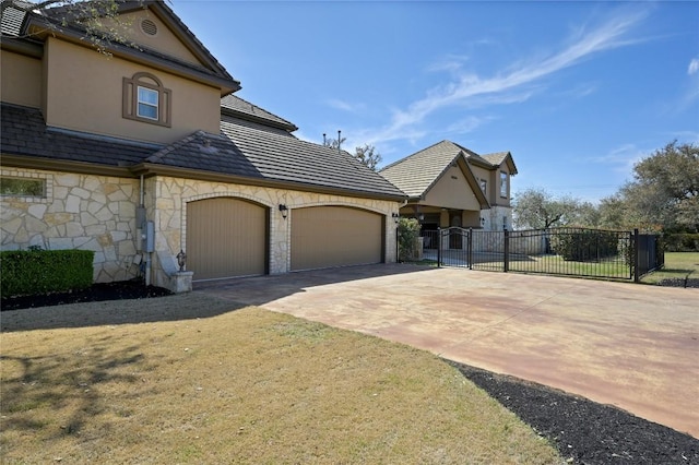2624 University Club Dr, Austin, TX 78732 - view of front of home featuring stucco siding, concrete driveway, a garage, and a gate