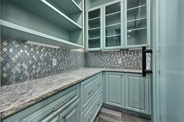 2624 University Club Dr, Austin, TX 78732 - kitchen featuring tasteful backsplash, open shelves, glass insert cabinets, and light stone countertops