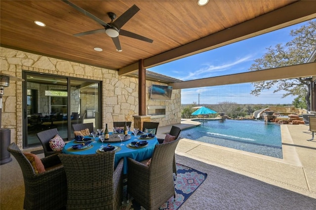2624 University Club Dr, Austin, TX 78732 - view of patio / terrace with an outdoor pool, a fireplace, outdoor dining area, and ceiling fan