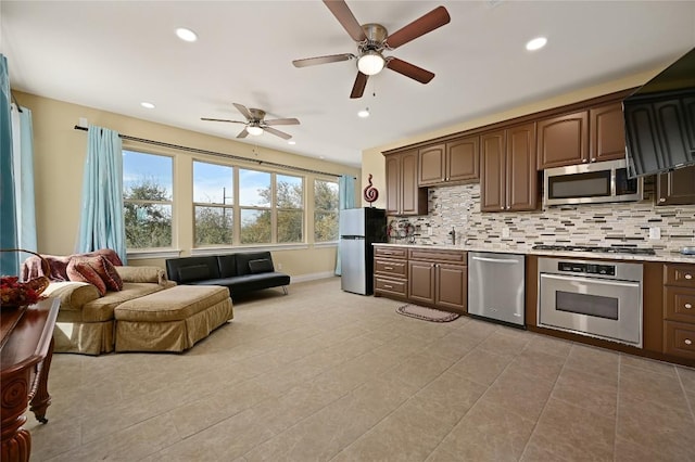 2624 University Club Dr, Austin, TX 78732 - kitchen featuring stainless steel appliances, plenty of natural light, backsplash, light countertops, and recessed lighting