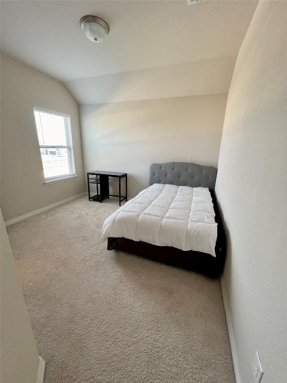 4413 Shady Hill Ln, Pflugerville, TX 78660 - bedroom with lofted ceiling, carpet flooring, and baseboards