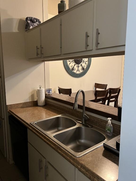 2905 Swisher St Unit 207, Austin, TX 78705 - kitchen with dark countertops, dishwasher, and gray cabinets