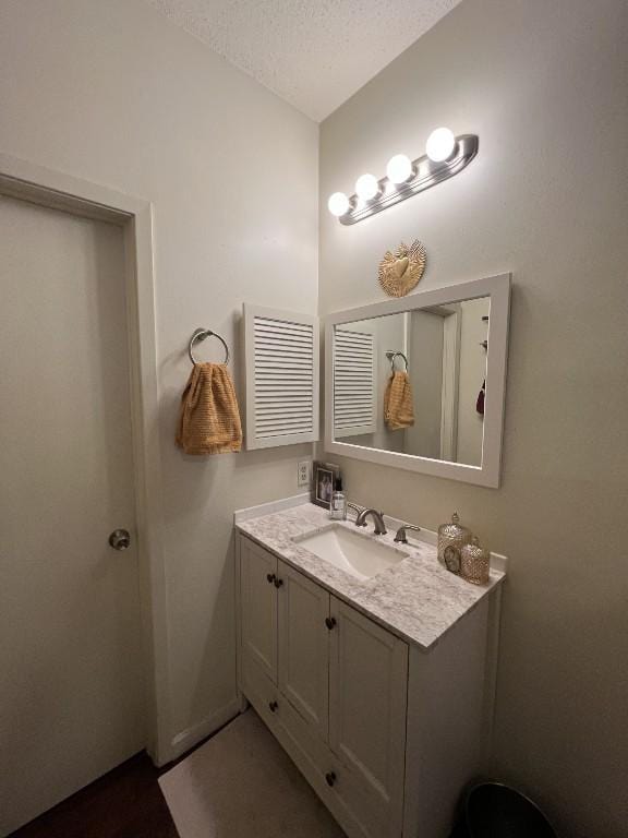 2905 Swisher St Unit 207, Austin, TX 78705 - bathroom featuring a textured ceiling and vanity