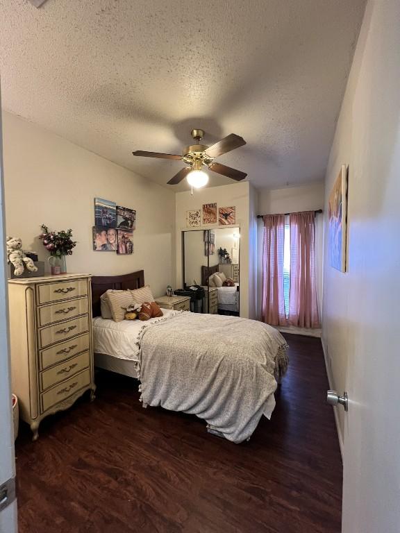 2905 Swisher St Unit 207, Austin, TX 78705 - bedroom featuring a textured ceiling, dark wood-style floors, and ceiling fan