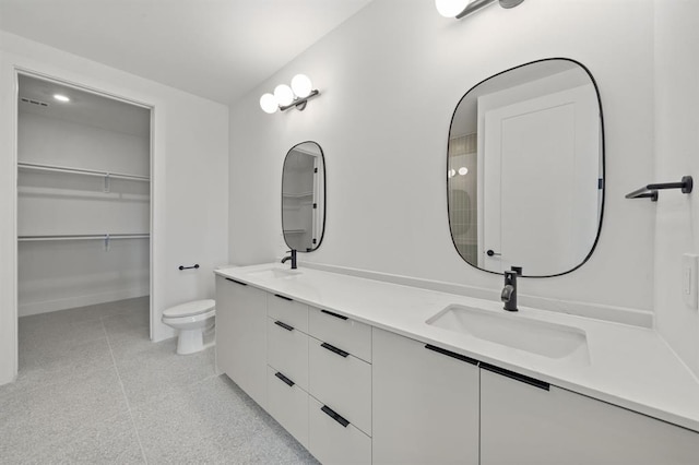1701 Simond Ave Unit 426, Austin, TX 78723 - full bathroom featuring double vanity, toilet, and a spacious closet