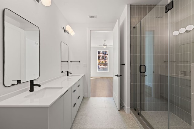 1701 Simond Ave Unit 426, Austin, TX 78723 - bathroom with double vanity, a stall shower, a ceiling fan, and baseboards