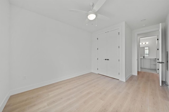 1701 Simond Ave Unit 426, Austin, TX 78723 - unfurnished bedroom with light wood-style flooring, baseboards, a closet, and ceiling fan