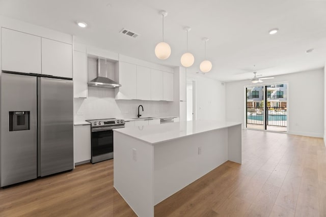 1701 Simond Ave Unit 426, Austin, TX 78723 - kitchen with appliances with stainless steel finishes, wall chimney exhaust hood, a sink, white cabinetry, and modern cabinets