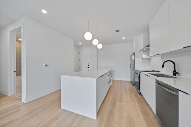1701 Simond Ave Unit 426, Austin, TX 78723 - kitchen with stainless steel appliances, a sink, modern cabinets, white cabinets, and light wood finished floors