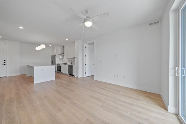 1701 Simond Ave Unit 426, Austin, TX 78723 - unfurnished living room with recessed lighting, baseboards, ceiling fan, and light wood-style flooring