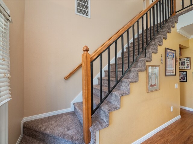 16501 Spotted Eagle Dr, Leander, TX 78641 - staircase with wood finished floors and crown molding