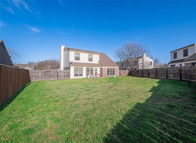 16501 Spotted Eagle Dr, Leander, TX 78641 - rear view of property featuring a chimney and a fenced backyard