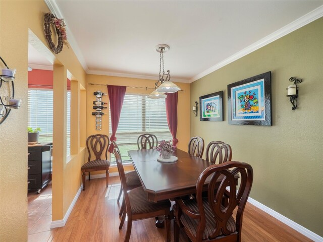 16501 Spotted Eagle Dr, Leander, TX 78641 - dining room featuring light wood-style flooring and ornamental molding