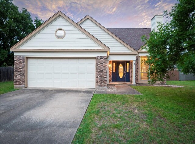 16501 Spotted Eagle Dr, Leander, TX 78641 - view of front facade featuring brick siding, concrete driveway, a garage, and a chimney