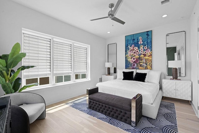 bedroom with recessed lighting, baseboards, a ceiling fan, wood finished floors, and visible vents