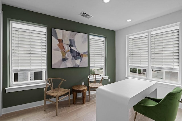 office space featuring recessed lighting, baseboards, visible vents, and light wood-type flooring